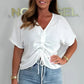 Alkalmi női felső V-nyakkivágással és nyakkendővel elöl, rövid ujjakkal